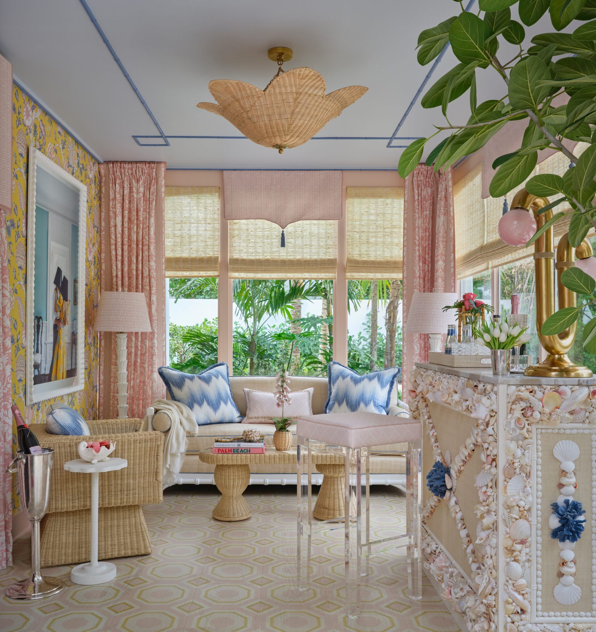 Sunroom with a rattan pendant, pink drapery and a shell-covered bar